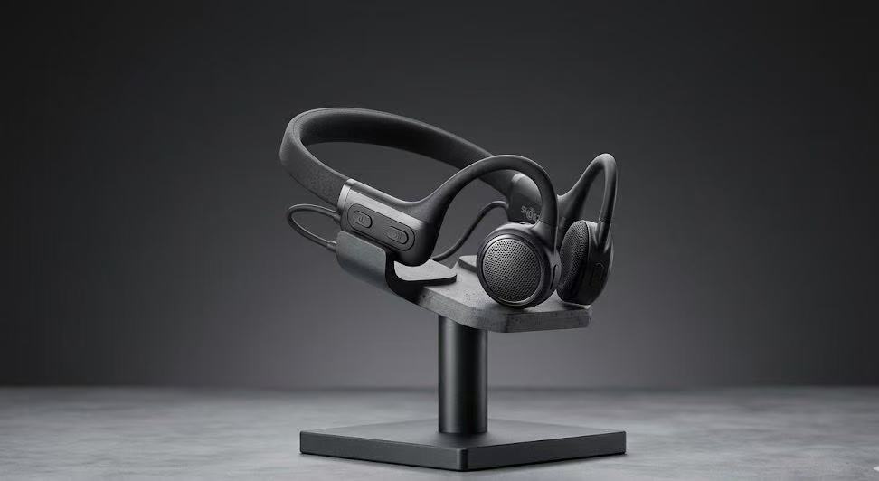 Closeup view of open ear wireless sports headphones on professional desk setup